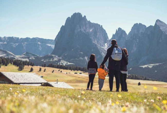 Familie mit Kindern beim Blick auf die Berge - familienhotel Dolomiten