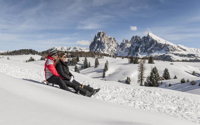 People on sledding track in the Dolomites.