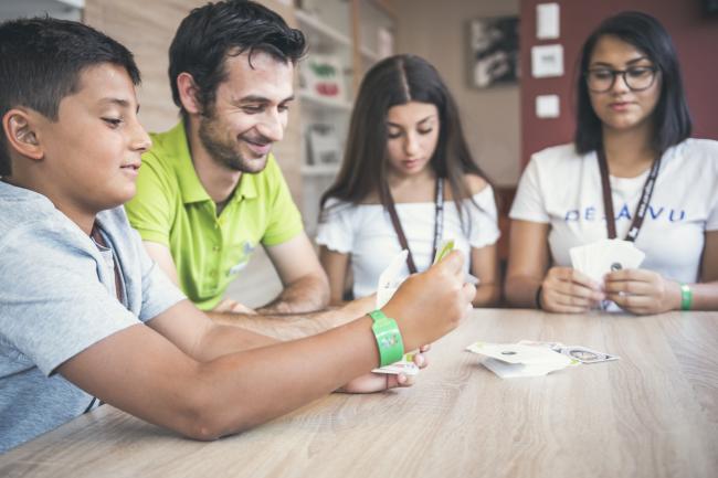 Famiglia con bambini che gioca a carte