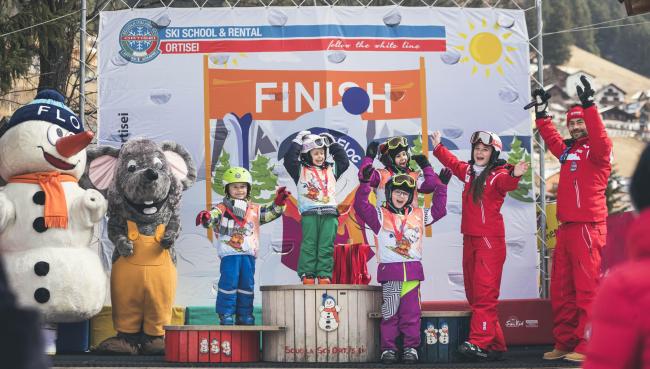 Kids on podium - best dolomites ski resort.