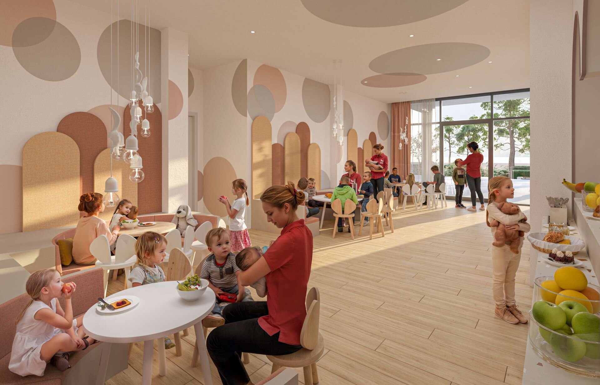 Bimbi dai 0 ai 5 anni giocano in una sala dedicata seguiti dalle animatrici per bambini.