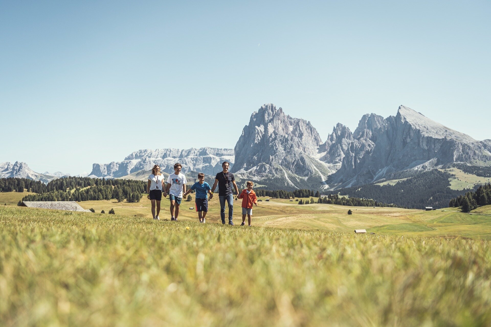 A family with children on the meadows of italian South Tyrol.