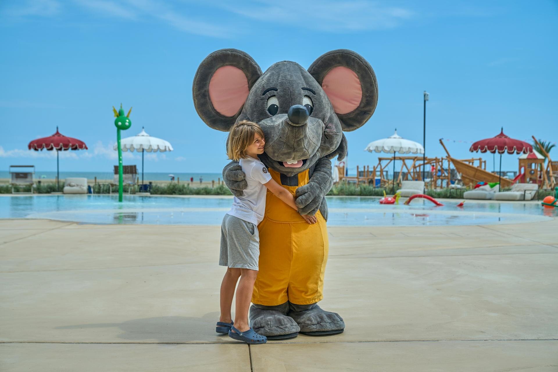 Bambino abbraccia Lino la mascotte del Cavallino Bianco a Caorle